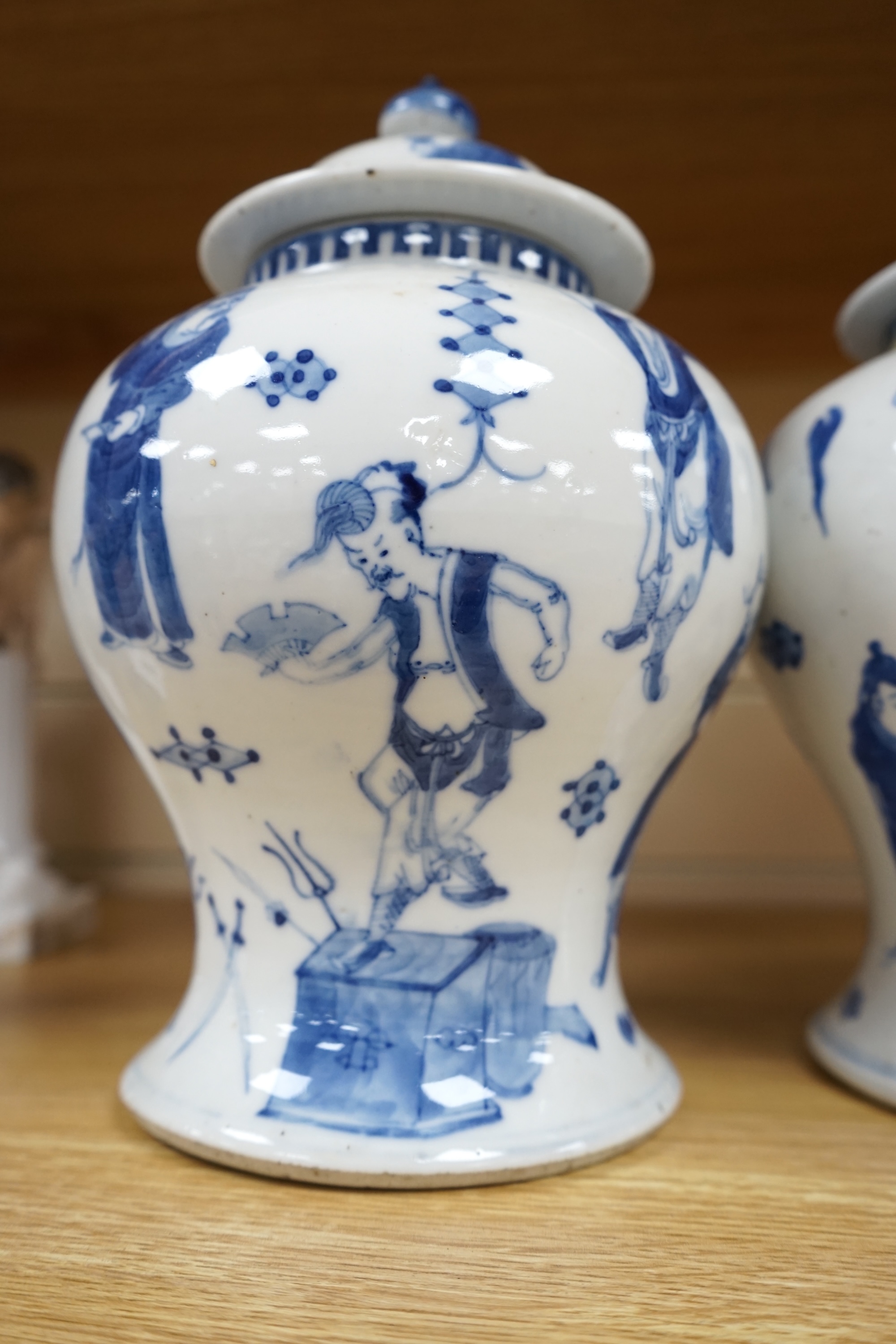 A pair of Chinese blue and white ‘street performers’ baluster vases, circa 1900, 25cm. 25.5cm. Condition - damaged